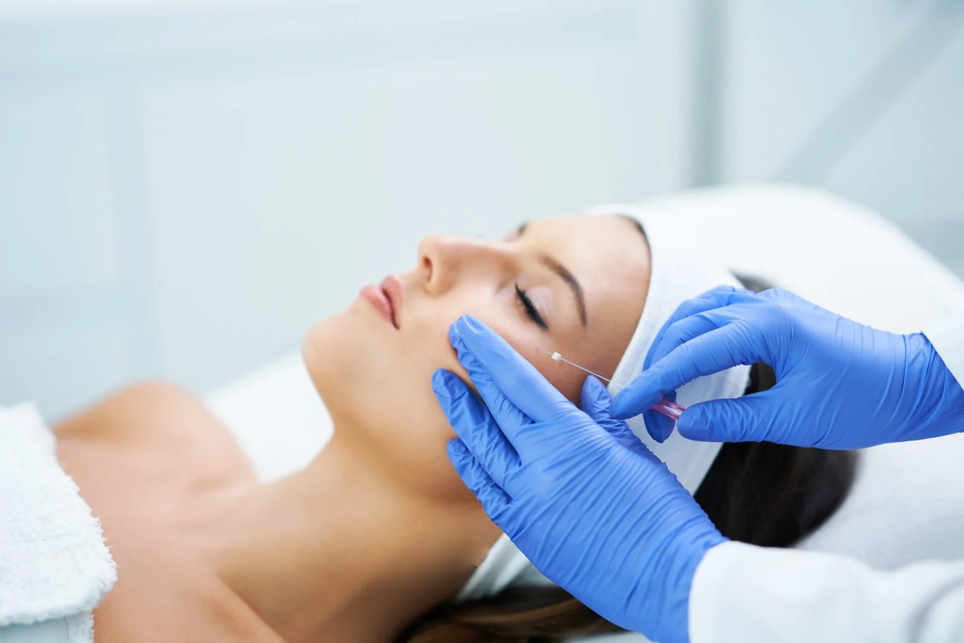 Beautiful young woman getting polydioxanone thread lifting at beauty salon. Beautiful young woman getting polydioxanone thread lifting at beauty salon.