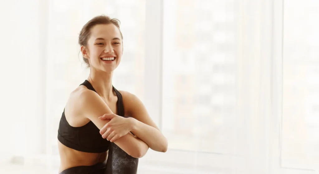 Woman in a Black Sports Bra Smiling