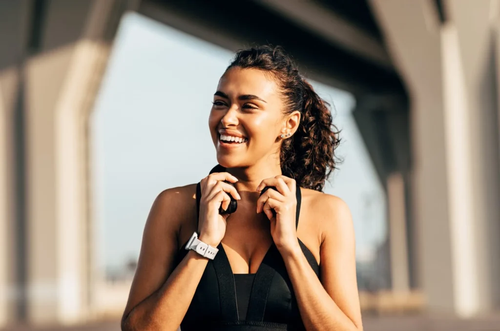 Beautiful happy woman holding headphones