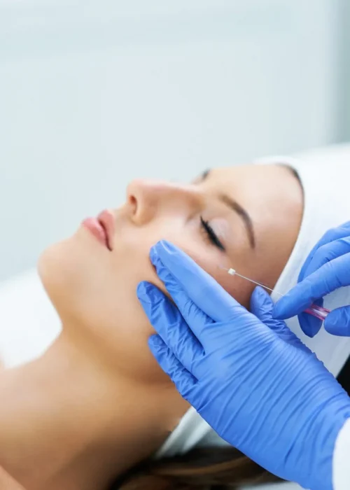 Beautiful young woman getting polydioxanone thread lifting at beauty salon.